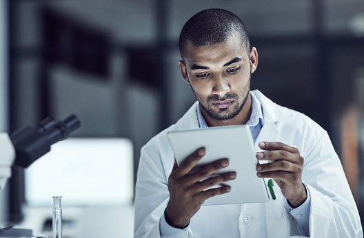 Man in bio lab using ipad